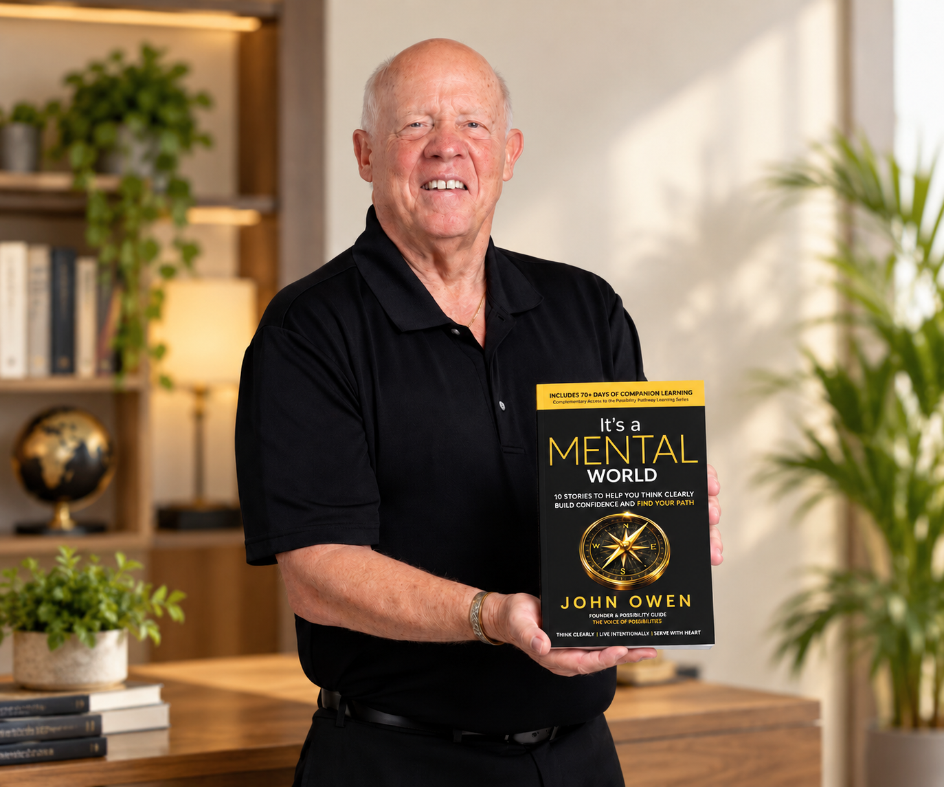 John Owen holding his book It's a Mental World